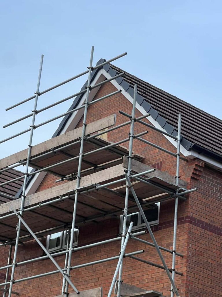 This is a photo of a roof which has just been repaired. There is a scaffold located at the gable end for access onto the roof. Works carried out by Branston Roofing Repairs